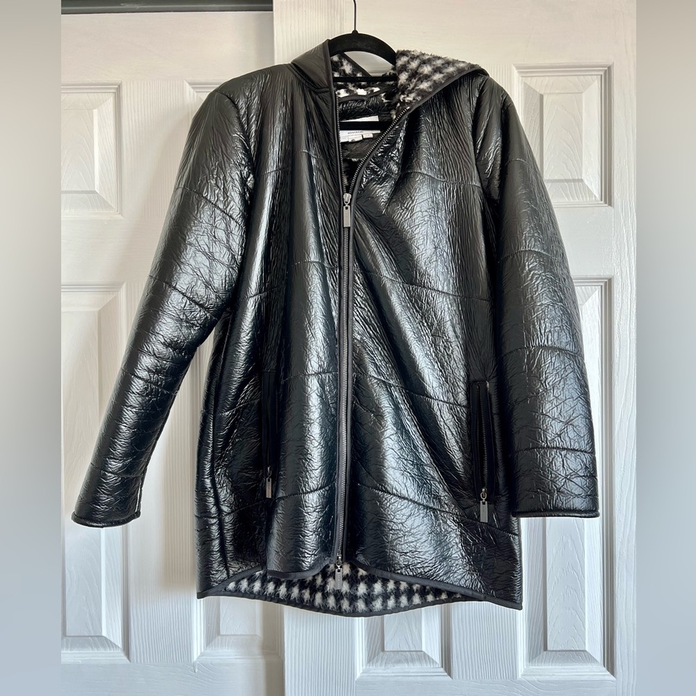 Black, shiny coat. Size small. Fuzzy white and black pattern inside. With hood